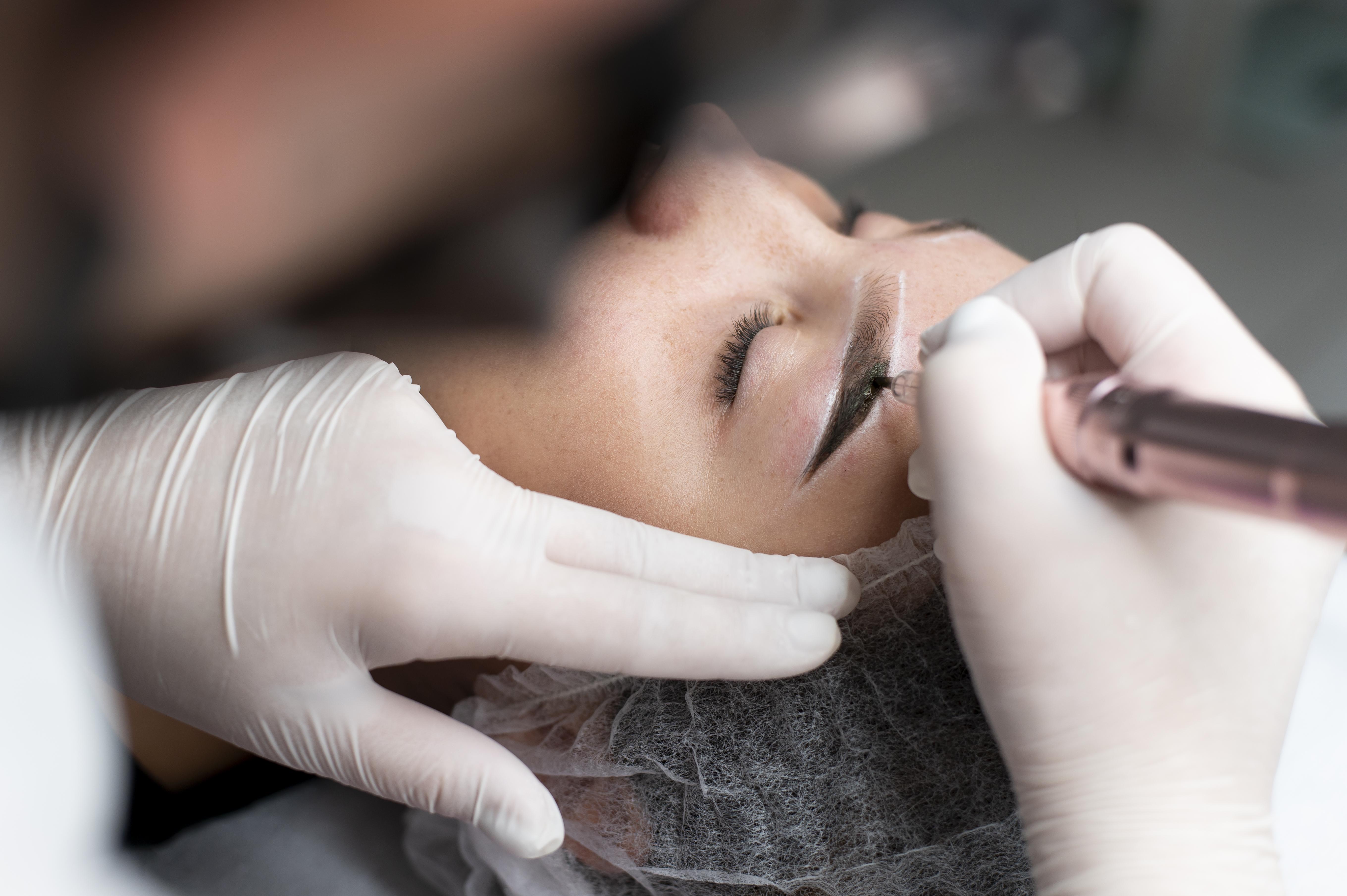 Junge Frau bei einer Microblading-Behandlung der Augenbrauen